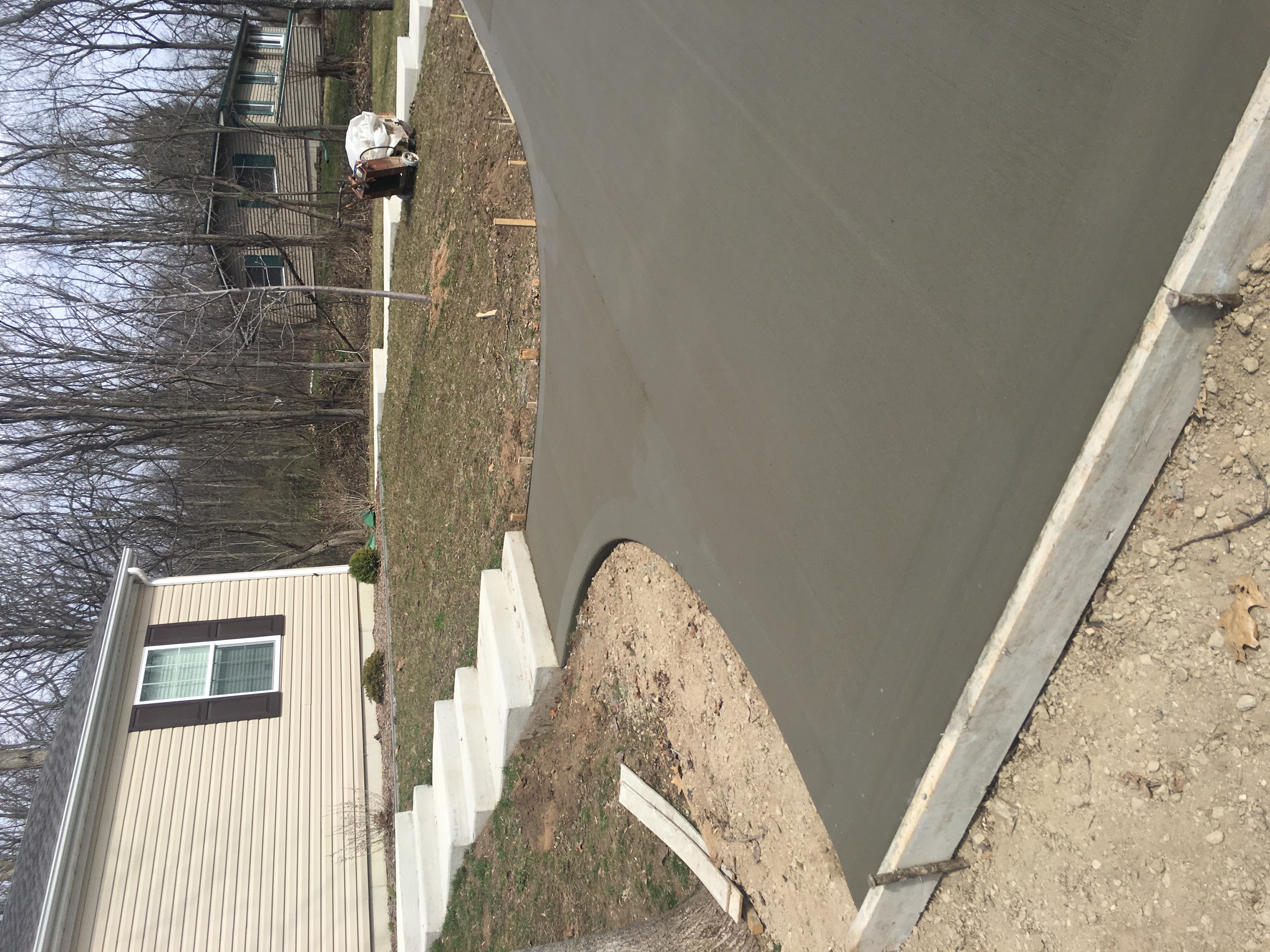 Finishing concrete driveway with curved edges at Klinger Lake in Sturgis Michigan